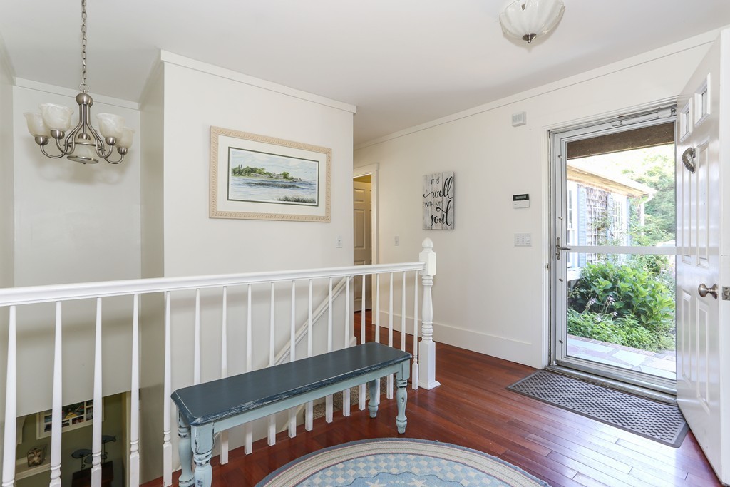 75 Deacon Court Barnstable, MA 02630 - Photo 8 of 30 a view of a hallway with wooden floor and windows