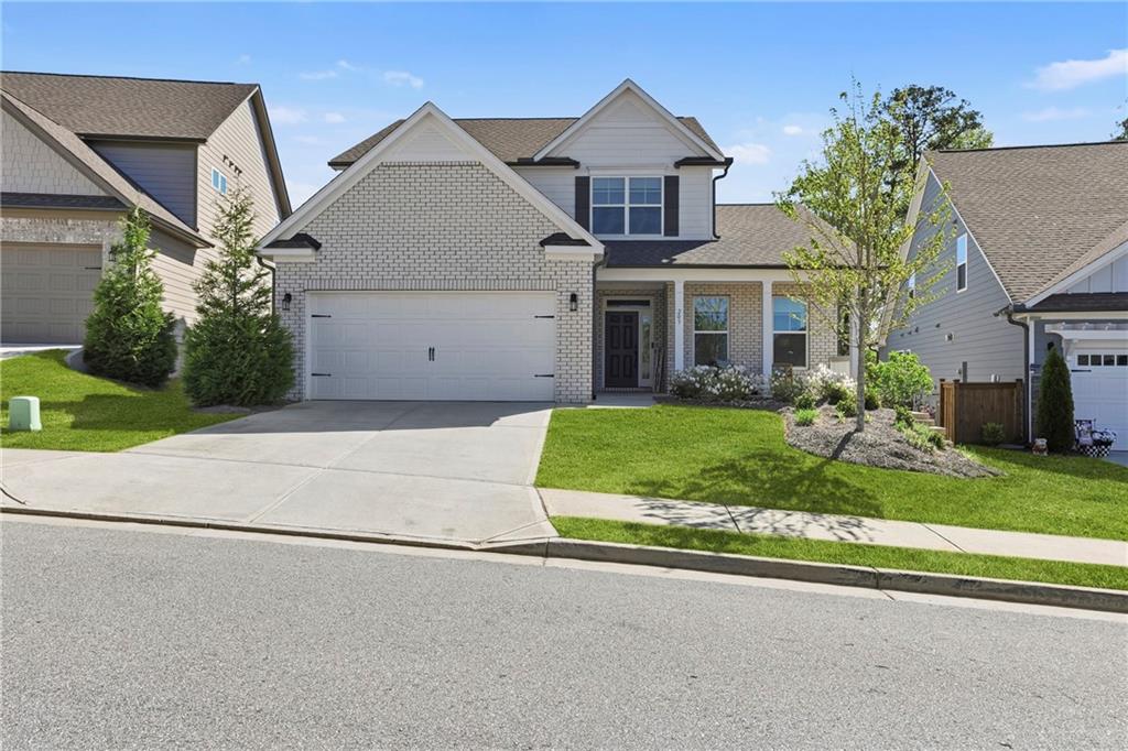 a front view of a house with a yard and garage