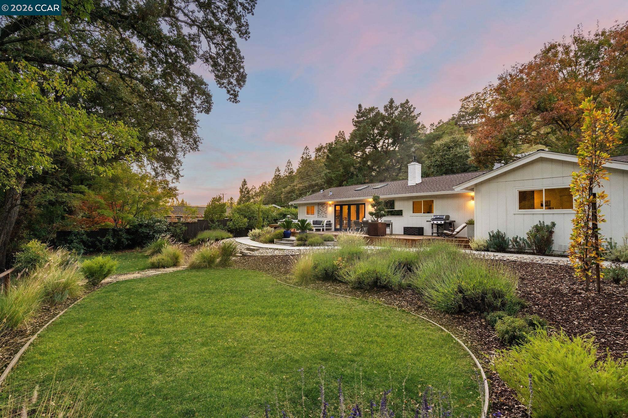 1886 Green Valley Road Alamo, CA 94507 - Photo 23 of 32 a front view of a house with garden and trees