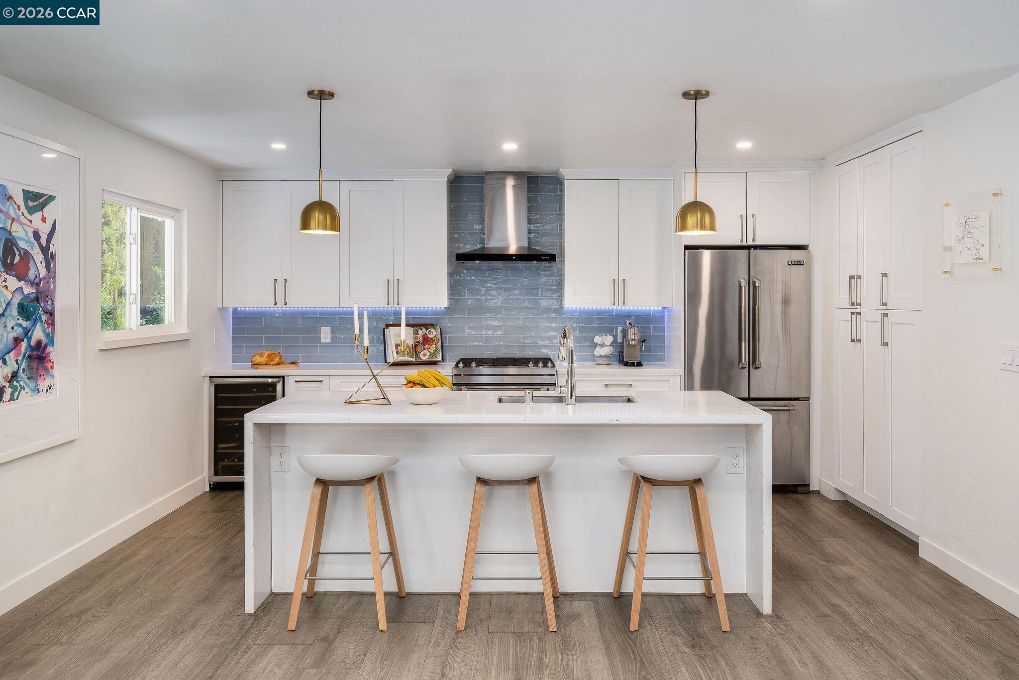 1886 Green Valley Road Alamo, CA 94507 - Photo 9 of 32 a kitchen with stainless steel appliances a dining table chairs refrigerator and sink