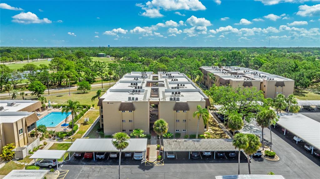 1330 Glen Oaks Drive East, Unit 374D Sarasota, FL 34232 - Photo 1 of 28 a view of a patio with table and chairs and potted plants