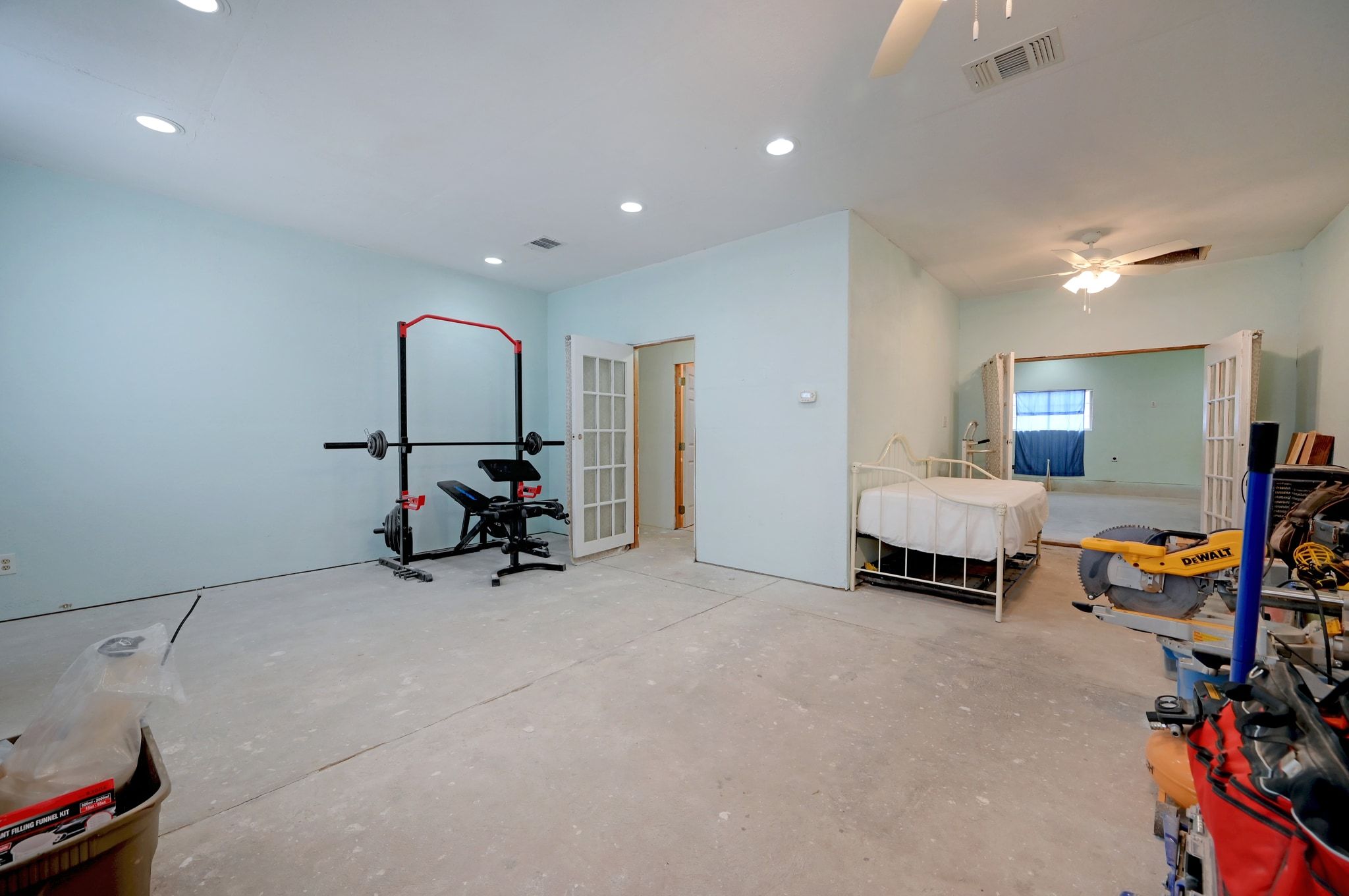 4598 Highway 173 Devine, TX 78016 - Photo 12 of 40 Bedroom featuring recessed lighting, concrete floors, and a ceiling fan