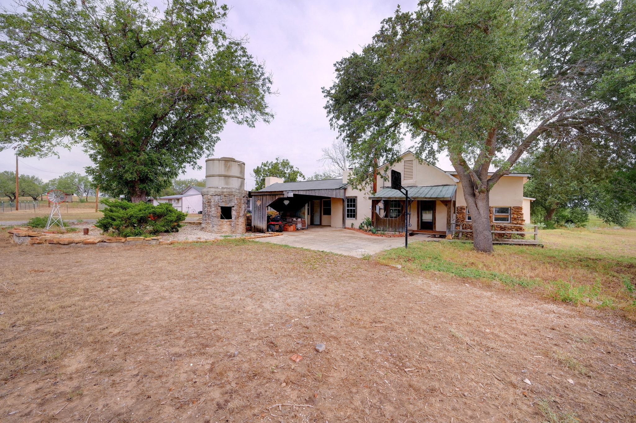 4598 Highway 173 Devine, TX 78016 - Photo 2 of 40 Front of main house with stone siding, stucco siding, and a metal roof