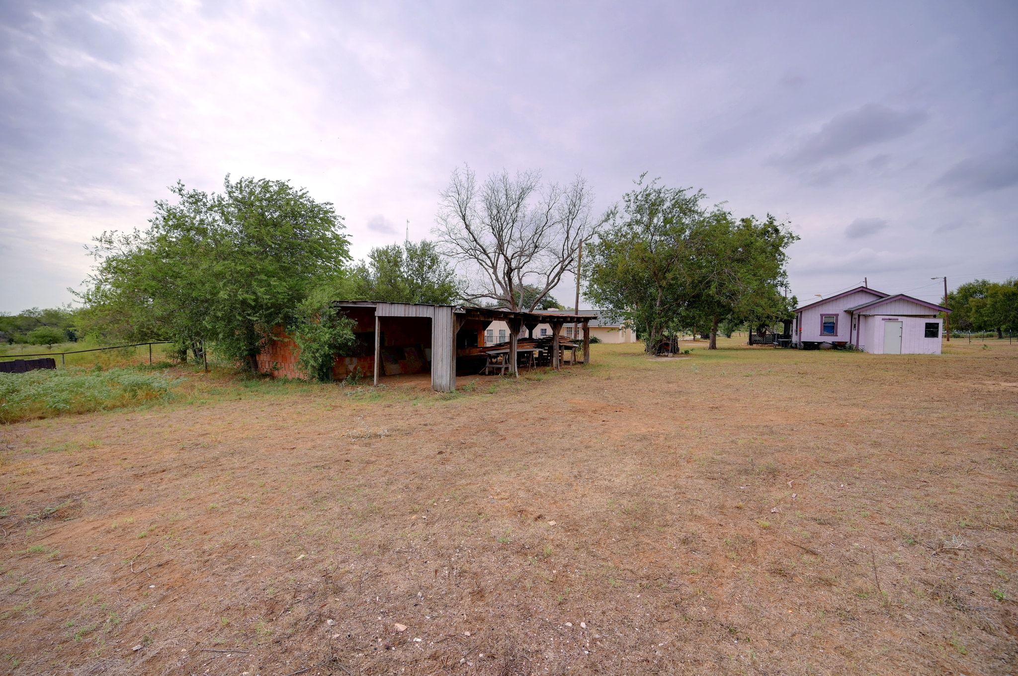 4598 Highway 173 Devine, TX 78016 - Photo 22 of 40 View of green lawn with an outbuilding and an outdoor structure