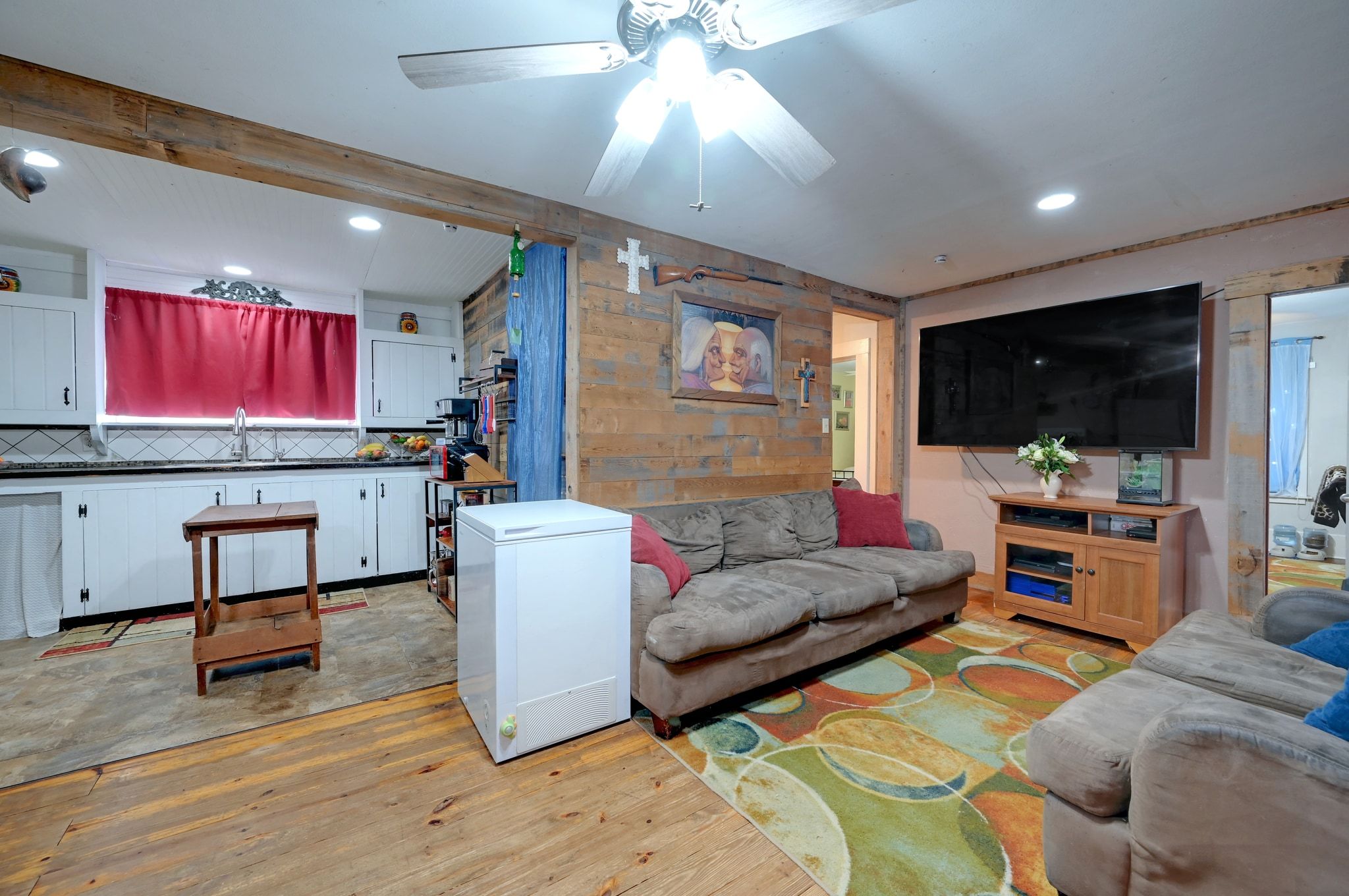 4598 Highway 173 Devine, TX 78016 - Photo 27 of 40 Living room with light wood finished floors, wooden walls, recessed lighting, and a ceiling fan