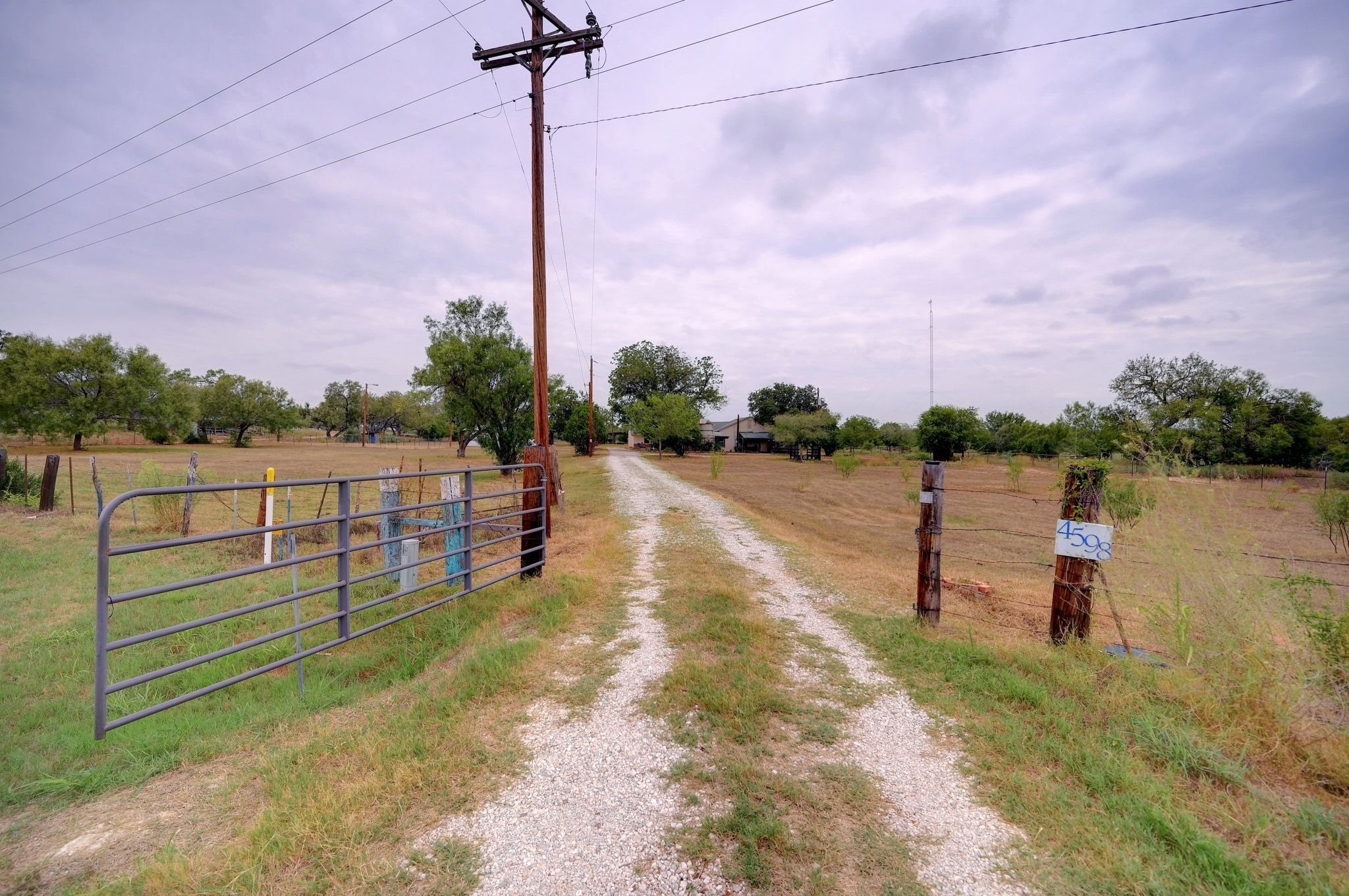 4598 Highway 173 Devine, TX 78016 - Photo 3 of 40 Driveway with a gated entry