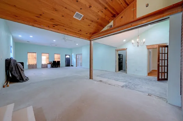 a gym room with furniture and a chandelier