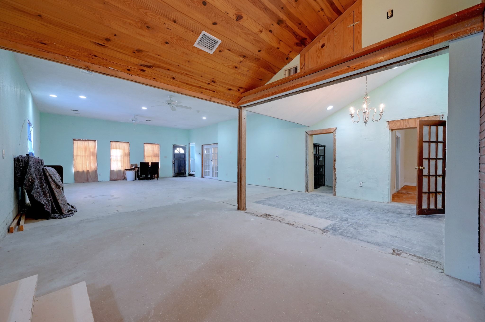 4598 Highway 173 Devine, TX 78016 - Photo 5 of 40 Unfurnished living room featuring concrete floors, recessed lighting, wooden ceiling, a chandelier