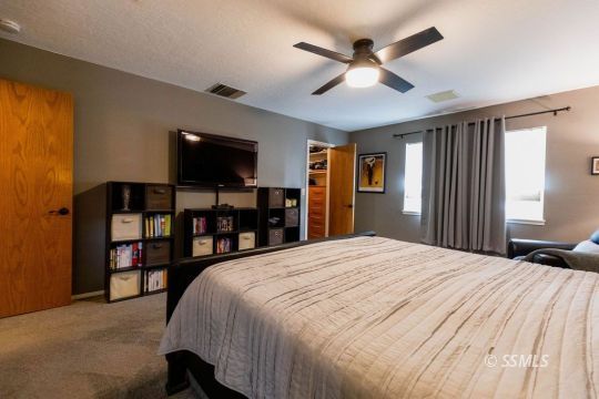 908 North Inyo Street Ridgecrest, CA 93555 - Photo 22 of 46 a bed room with a bed and a television
