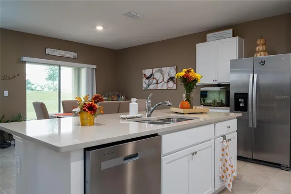 a dining room with furniture a rug and a window