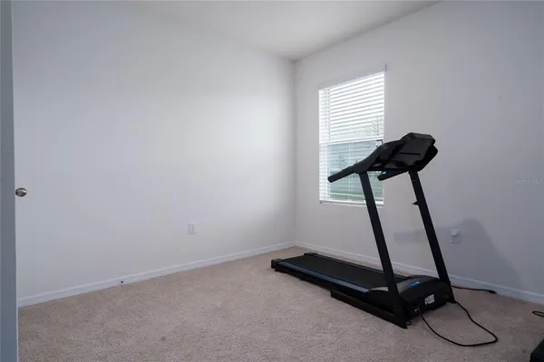 a bedroom with a bed and gym equipment