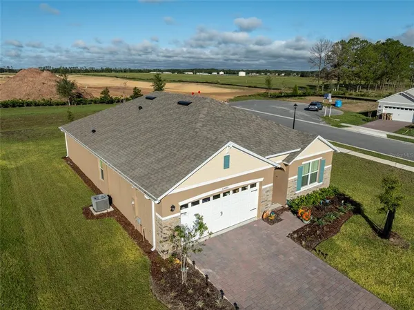an aerial view of a house with a ocean view
