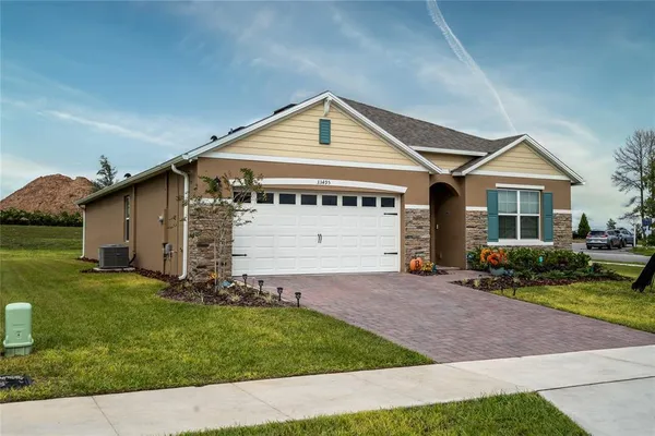a view of a house with backyard and sitting area