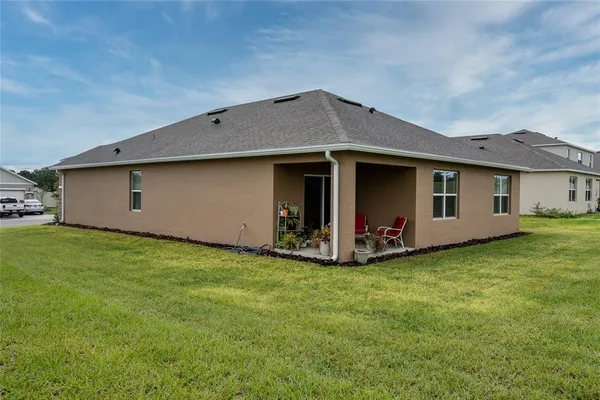 a front view of house with yard and green space