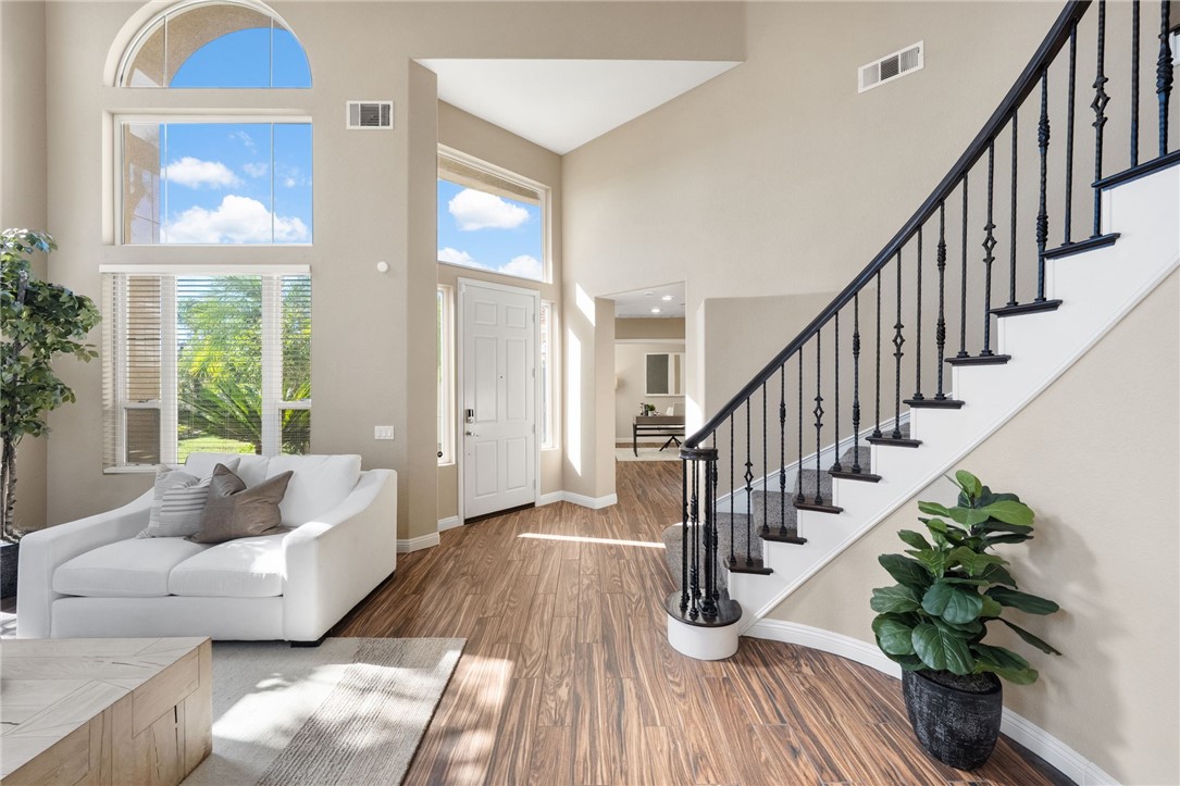 31465 Inverness Court Temecula, CA 92591 - Photo 9 of 75 Dramatic two-story ceilings create an impressive sense of openness in the formal living room | Professionally Staged