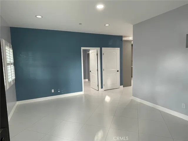 an empty room with closet and wooden door