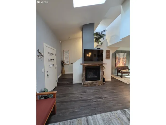 a view of living room with furniture and a fireplace