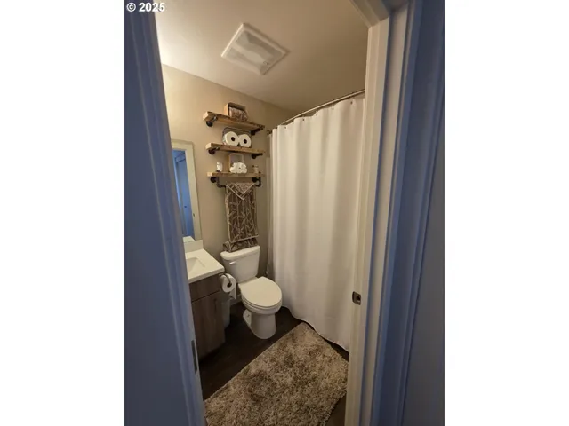 a bathroom with a toilet and a shower