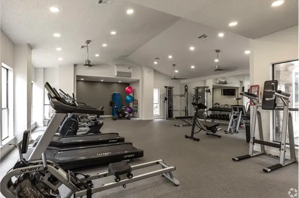 a room with gym equipment and a large window