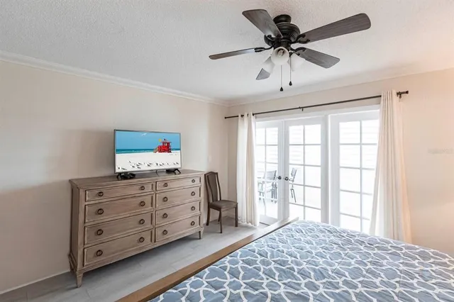 a bedroom with a bed and a television