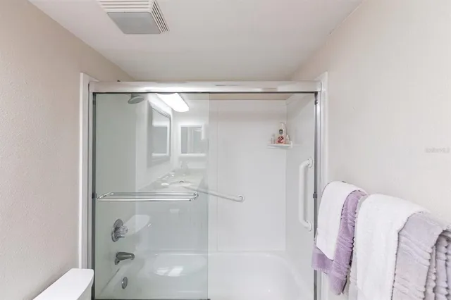 a bathroom with a glass shower door