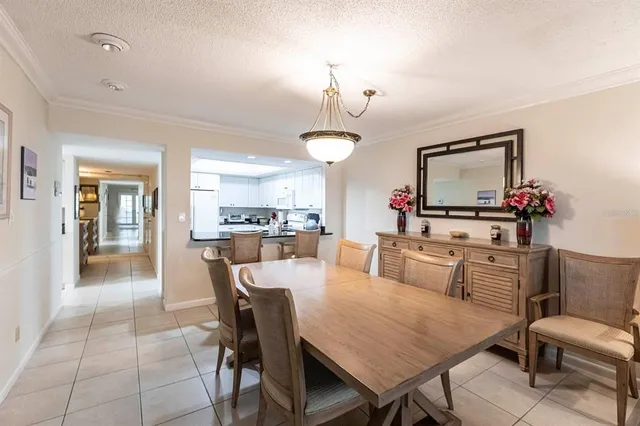 a view of a dining room with furniture and chandelier