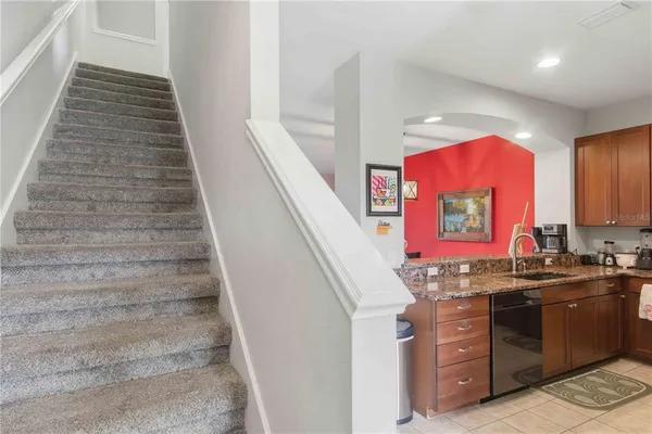 a kitchen with stainless steel appliances granite countertop a refrigerator stove top oven and sink