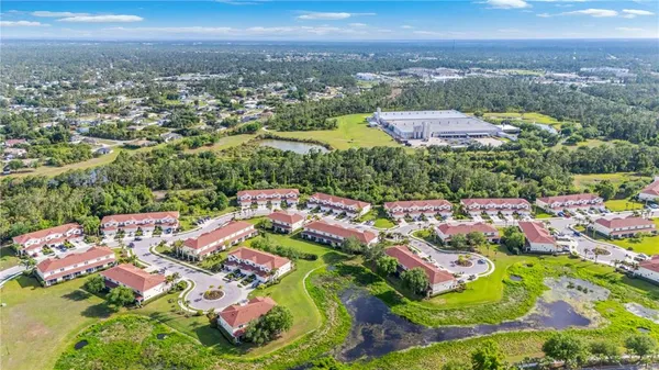 an aerial view of residential houses with outdoor space and street view
