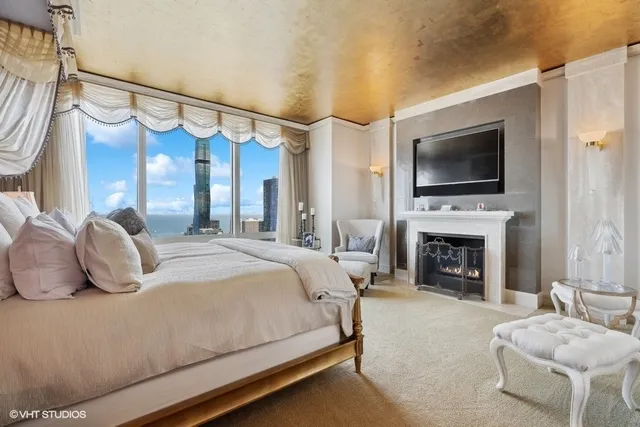 a bedroom with a bed and a fireplace