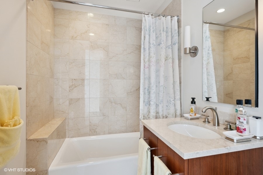 401 North Wabash Avenue, Unit 48A Chicago, IL 60611 - Photo 17 of 50 a bathroom with a sink and a mirror