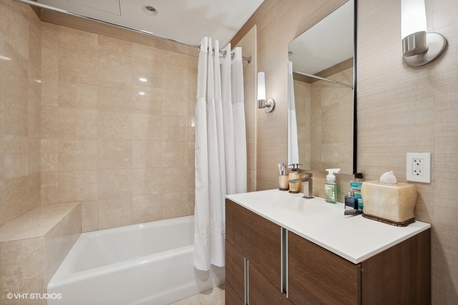 401 North Wabash Avenue, Unit 48A Chicago, IL 60611 - Photo 18 of 50 a bathroom with a sink and a mirror