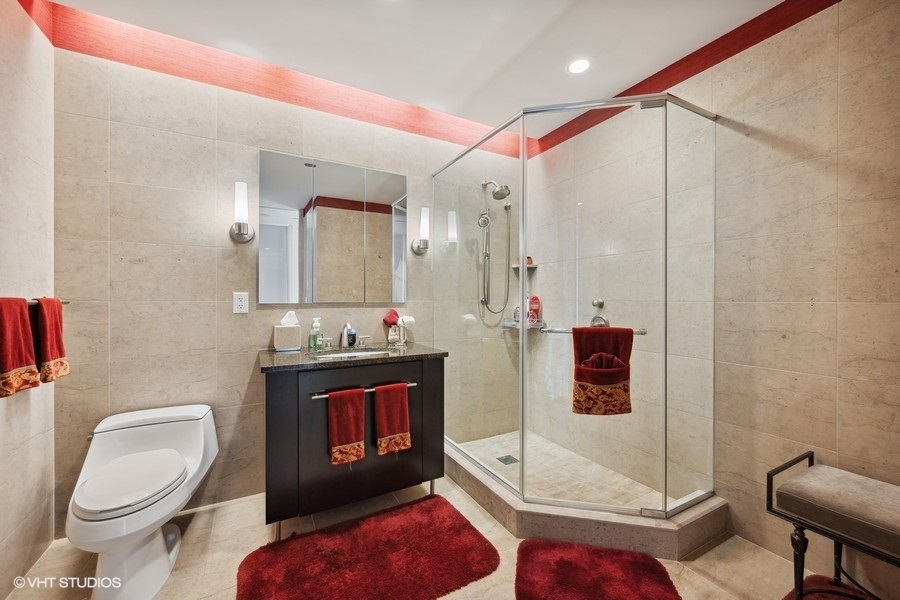 401 North Wabash Avenue, Unit 48A Chicago, IL 60611 - Photo 20 of 50 a bathroom with a sink a toilet and a mirror