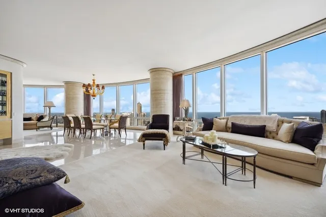 a living room with furniture and large windows