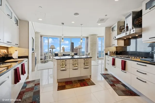 a kitchen with stainless steel appliances a stove a sink and a refrigerator