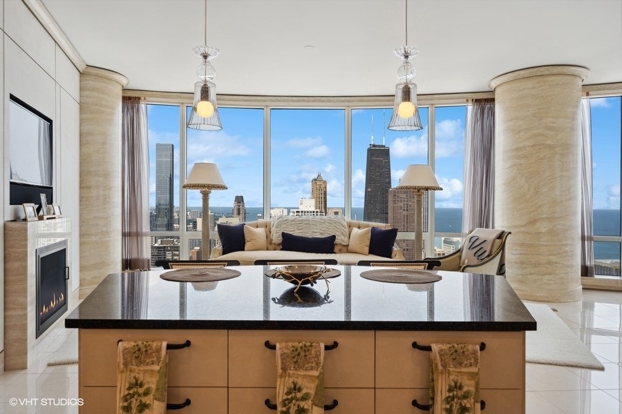 401 North Wabash Avenue, Unit 48A Chicago, IL 60611 - Photo 6 of 50 a kitchen with kitchen island granite countertop a sink and cabinets