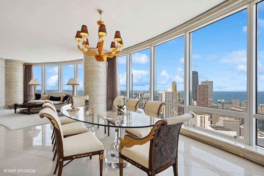 401 North Wabash Avenue, Unit 48A Chicago, IL 60611 - Photo 9 of 50 a dining room with furniture a chandelier and wooden floor