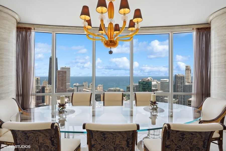 401 North Wabash Avenue, Unit 48A Chicago, IL 60611 - Photo 10 of 50 a view of a dining room with furniture a chandelier and large windows