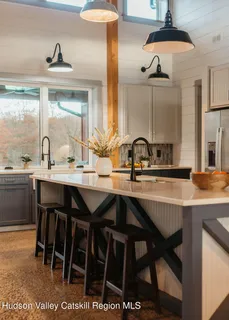 a kitchen with a sink and a large window