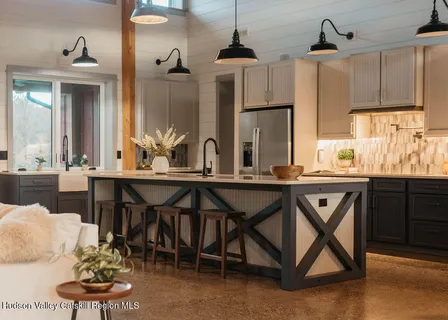 a kitchen with a table chairs stove and cabinets