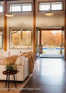 a view of backyard with swimming pool and seating space