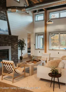 a living room with furniture wooden floor and a fireplace