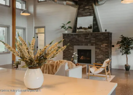 a view of a livingroom with furniture and a fireplace