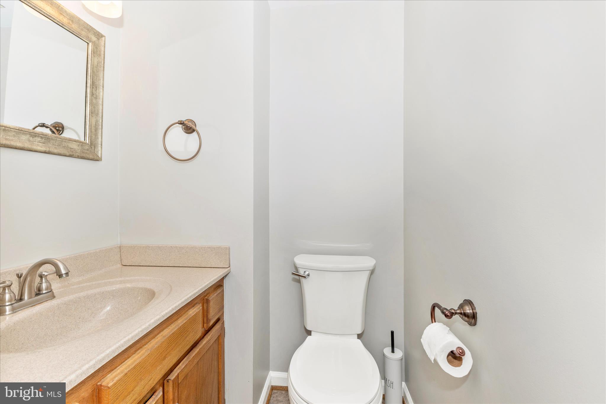 8204 Red Wing Court Frederick, MD 21701 - Photo 13 of 58 a bathroom with a toilet sink vanity and mirror