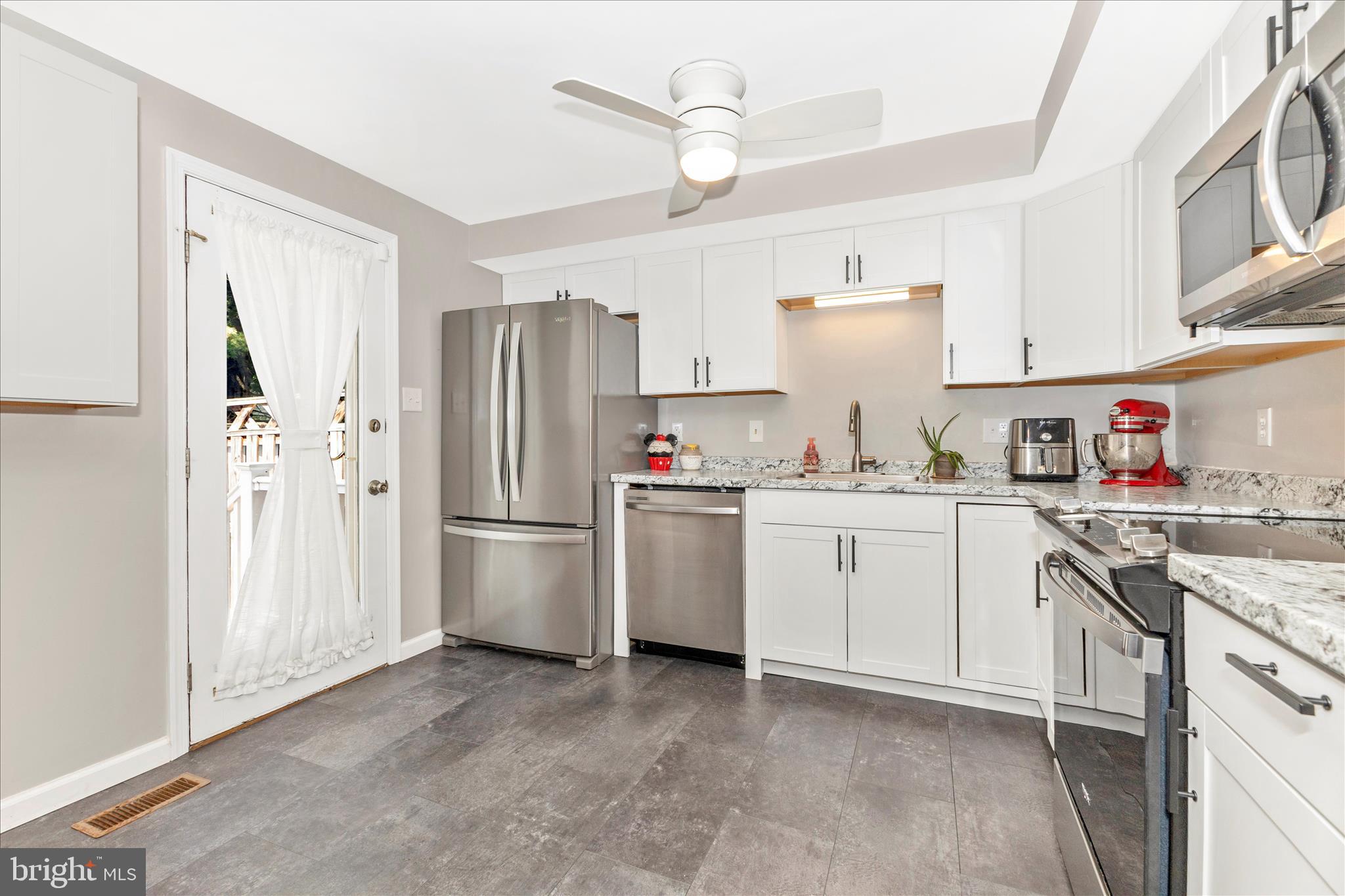 8204 Red Wing Court Frederick, MD 21701 - Photo 10 of 58 a kitchen with white cabinets and white appliances