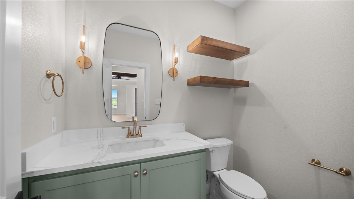 162 Buffalo Rdg Road Giddings, TX 78942 - Photo 11 of 31 a bathroom with a toilet sink and mirror