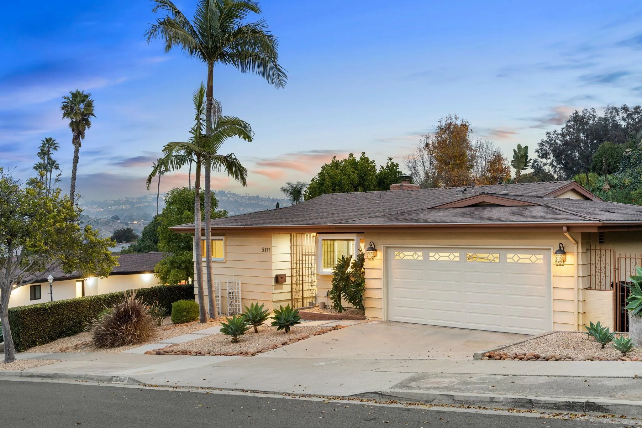 5111 Dorman Drive San Diego, CA 92115 - Photo 1 of 59 a front view of a house with a garden and a yard
