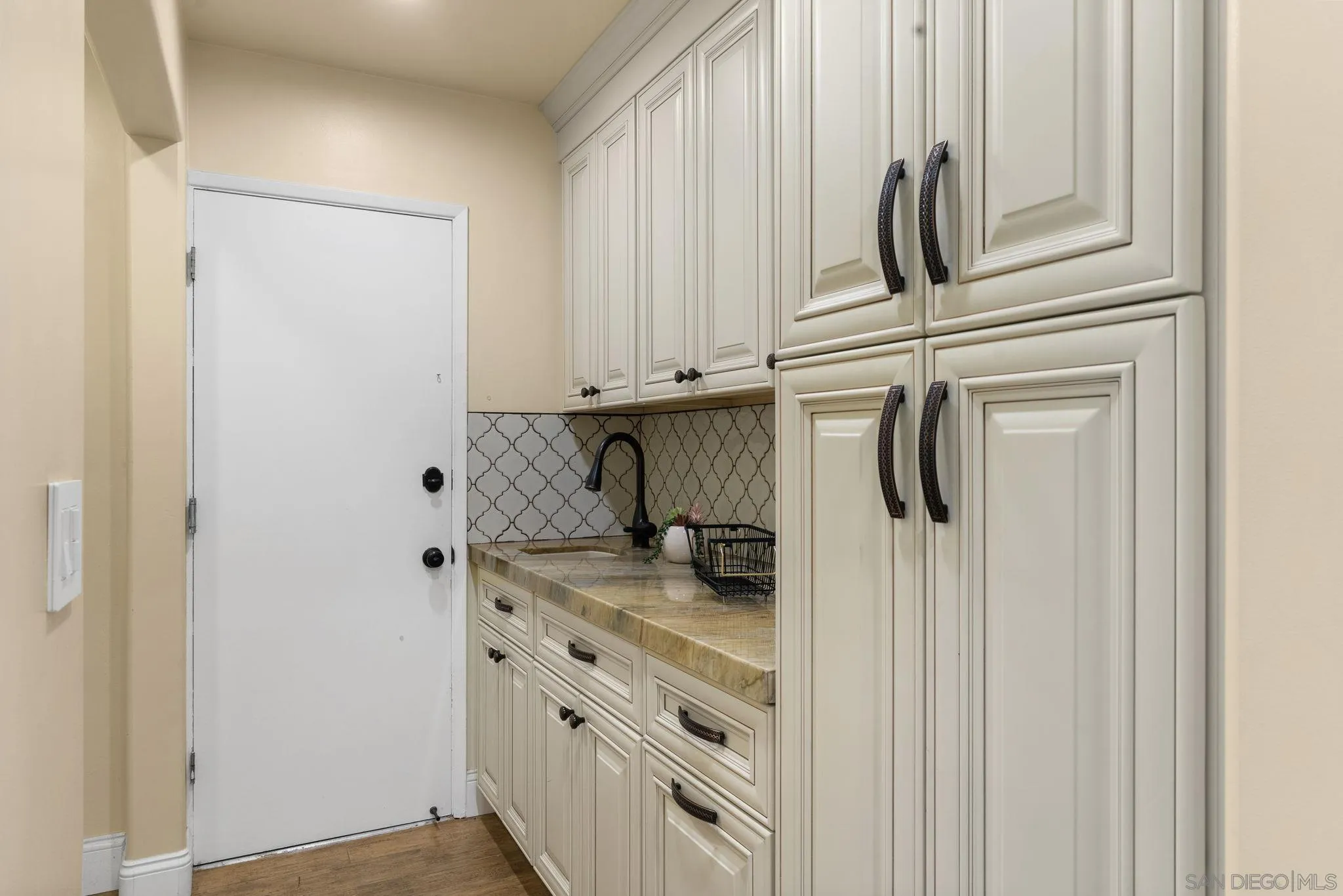 5111 Dorman Drive San Diego, CA 92115 - Photo 11 of 59 a bathroom with a granite countertop sink and a white cabinet