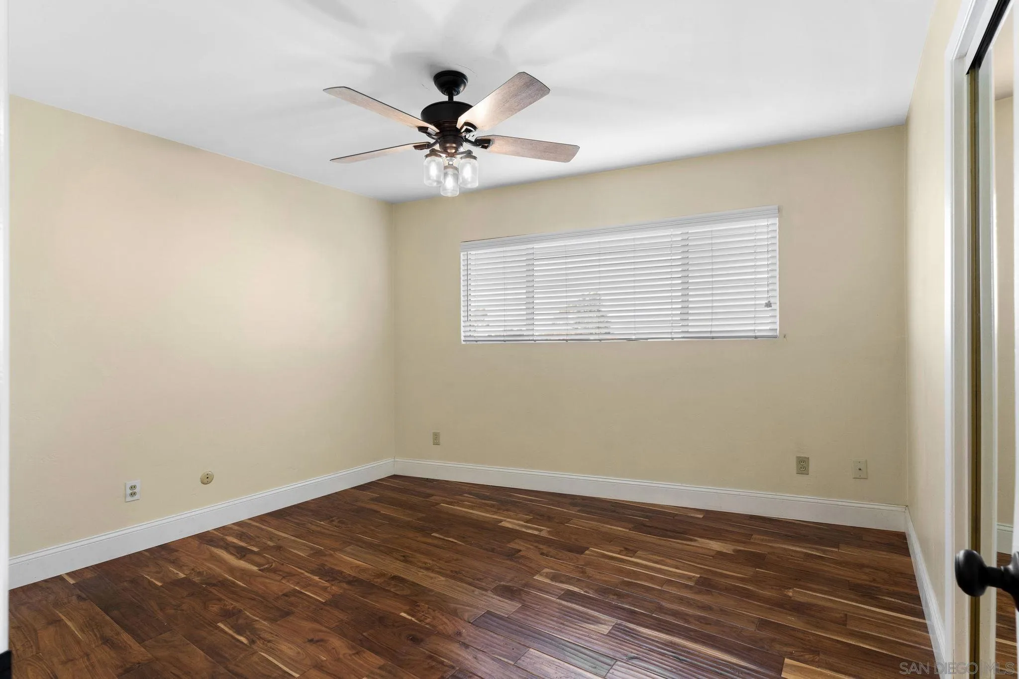 5111 Dorman Drive San Diego, CA 92115 - Photo 22 of 59 a view of a room with wooden floor and natural light