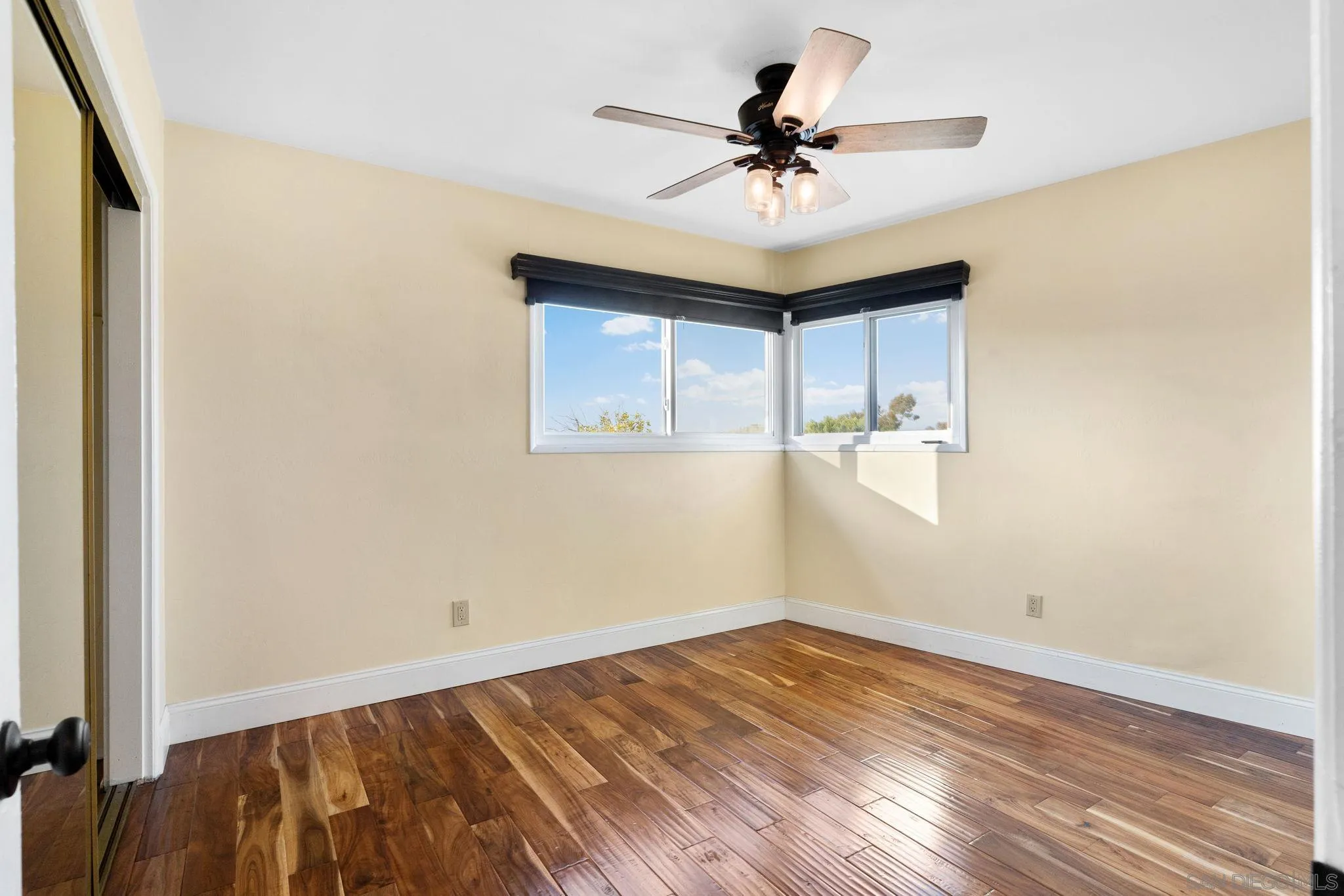 5111 Dorman Drive San Diego, CA 92115 - Photo 23 of 59 a view of empty room with wooden floor and fan