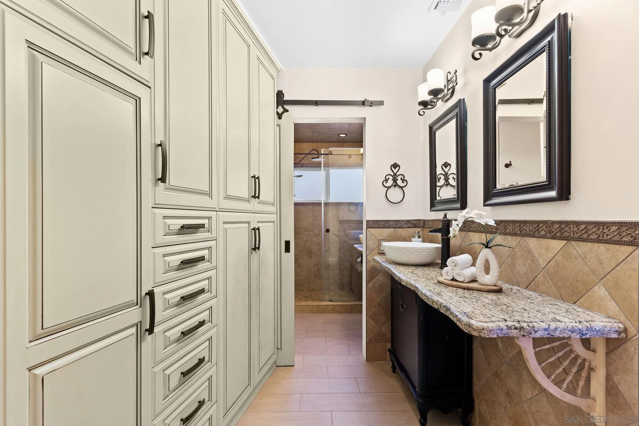 5111 Dorman Drive San Diego, CA 92115 - Photo 30 of 59 a bathroom with a granite countertop sink and a mirror